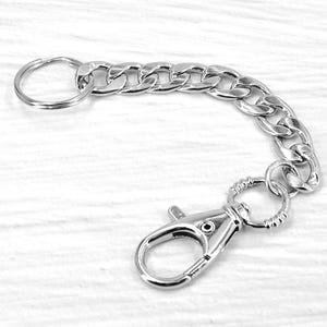 May include: Silver-colored keychain with a lobster clasp and a chain link design. The keychain includes a split ring for keys and a clasp for attaching to a bag or belt loop. The chain is approximately 5 inches long.