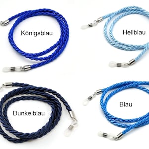 May include: Four different colors of eyeglass cords, each with silver metal clasps. The colors are royal blue, light blue, dark blue, and blue. The cords are made of twisted rope.