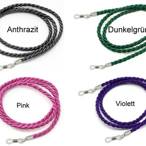 May include: Four different colors of eyeglass chains. The colors are anthracite, dark green, pink, and violet. Each chain has silver metal clasps on the ends.