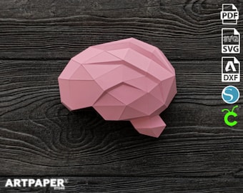 May include: A pink papercraft model of a human brain. The model is made of folded paper and has a geometric design. The model is on a dark wood background.