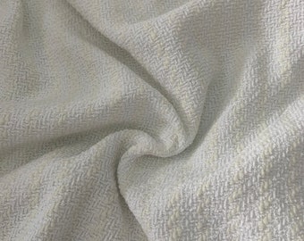 May include: White textured fabric with a subtle herringbone pattern. The fabric is soft and has a slightly raised texture.