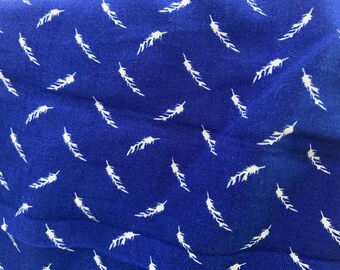 May include: A blue fabric with a white feather pattern.