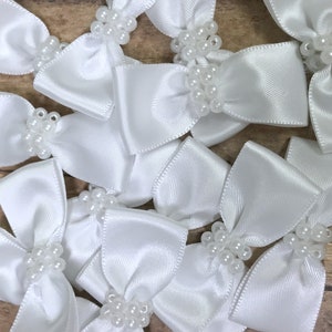 White satin bow ties with pearls.  Bows.  Ribbon supplies.  Supplies.