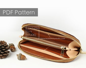 May include: Open brown leather wallet with two zippered compartments. The wallet has multiple card slots and a billfold. The zipper pulls are gold metal. The wallet is labeled "Leather DIY Studio" and "www.leatherdiystudio.com".