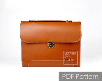 May include: A brown leather briefcase with a gold clasp and stitching. The briefcase has the text "LEATHER D/Y STUDIO" on the front.