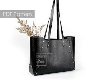 May include: Black leather tote bag with a zipper closure and a top handle. The bag has a  "Leather DIY Studio" logo on the front.  PDF Pattern.