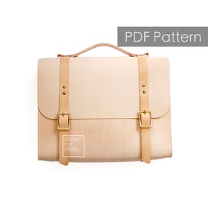 May include: A light brown leather briefcase with two adjustable straps and brass buckles. The briefcase has a top handle and a label that reads "Leather DIY Studio".