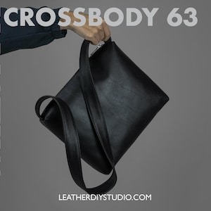 Peut inclure: Un sac à bandoulière en cuir noir avec une longue sangle. Le sac est tenu par une main. Le texte "PDF PATTERN CROSSBODY 63" est visible dans le coin supérieur gauche de l'image. Le texte "LEATHERDIYSTUDIO.COM" est visible dans le centre inférieur de l'image.