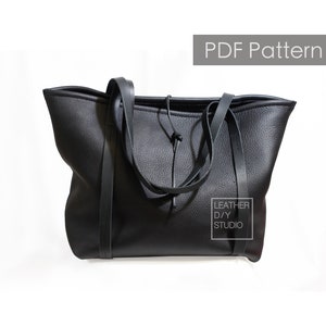 May include: Black leather tote bag with a drawstring closure and wide straps. The bag has a "Leather DIY Studio" label on the side.