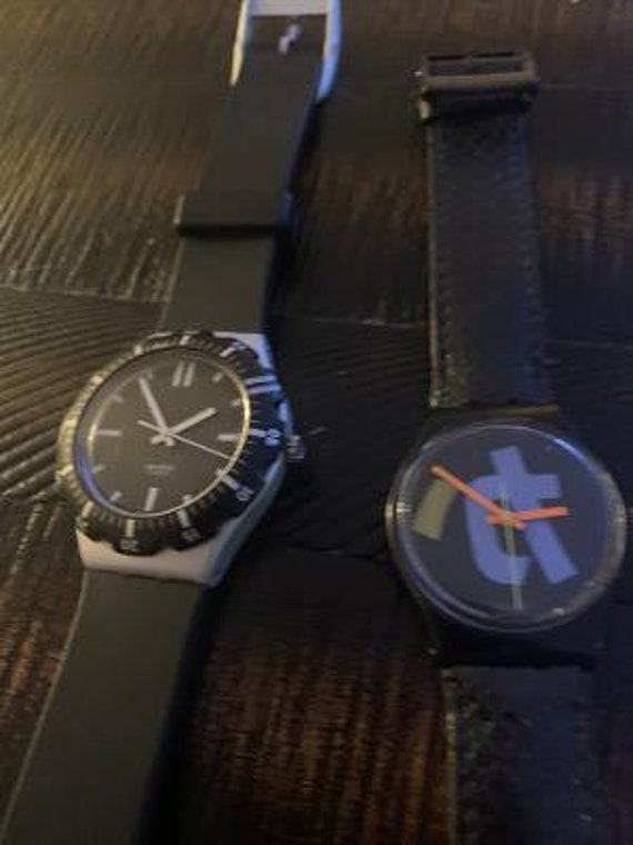 2 swatch black watches