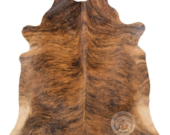 Könnte beinhalten: Ein brauner und schwarzer Kuhfellteppich mit einem natürlichen, rustikalen Look. Das Fell ist weich und geschmeidig, mit einem einzigartigen Muster aus braunen und schwarzen Markierungen. Der Teppich ist perfekt, um jedem Raum einen Hauch von Western-Charme zu verleihen.