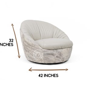May include: A white leather swivel chair with a rounded back and a 32 inch height and 42 inch width.