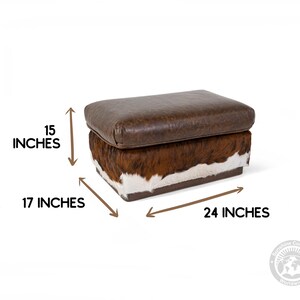 May include: A brown leather and cowhide storage ottoman with a rectangular shape. The ottoman measures 15 inches high, 17 inches wide, and 24 inches long.