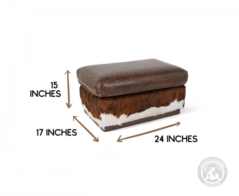 May include: A brown leather and cowhide storage ottoman with a rectangular shape. The ottoman measures 15 inches high, 17 inches wide, and 24 inches long.