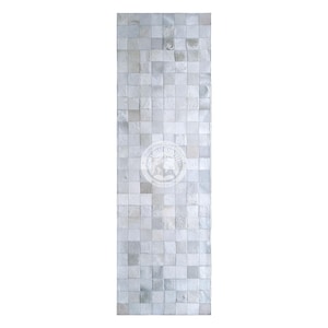 May include: A rectangular, light gray rug with a mosaic pattern of small, square tiles. The rug features a circular emblem in the center. The rug is made of a soft material and is suitable for various spaces.