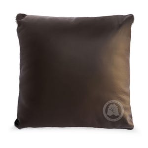 May include: A dark brown leather pillow with a circular logo that says "Luxury Comfort" in white text.