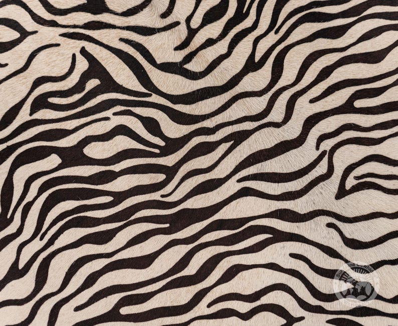 May include: Black and white zebra print fabric with a soft, fuzzy texture.