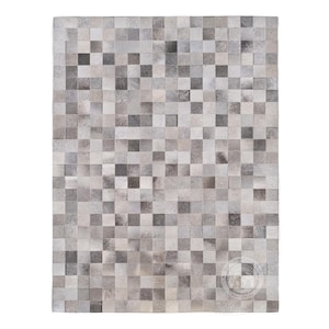 May include: A gray and white patchwork rug made of cowhide squares.