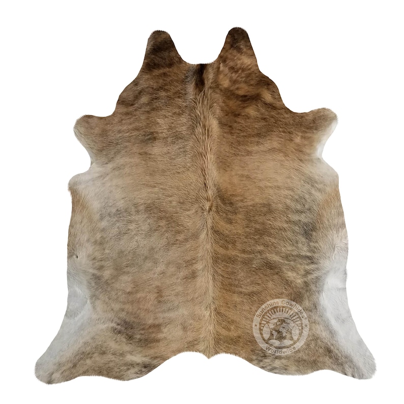 May include: A brown and white cowhide rug with a natural, spotted pattern. The rug is approximately 1.5 metres by 2.1 metres in size.