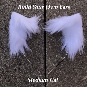 May include: White faux fur cat ears headband, with the text "Build Your Own Ears" and "Medium Cat" on the image.