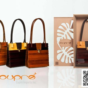 May include: Three wooden handbags with leather handles and accents. The bags feature a rectangular design with horizontal wooden slats in shades of brown and tan. One bag is displayed in a box with a tropical leaf design.