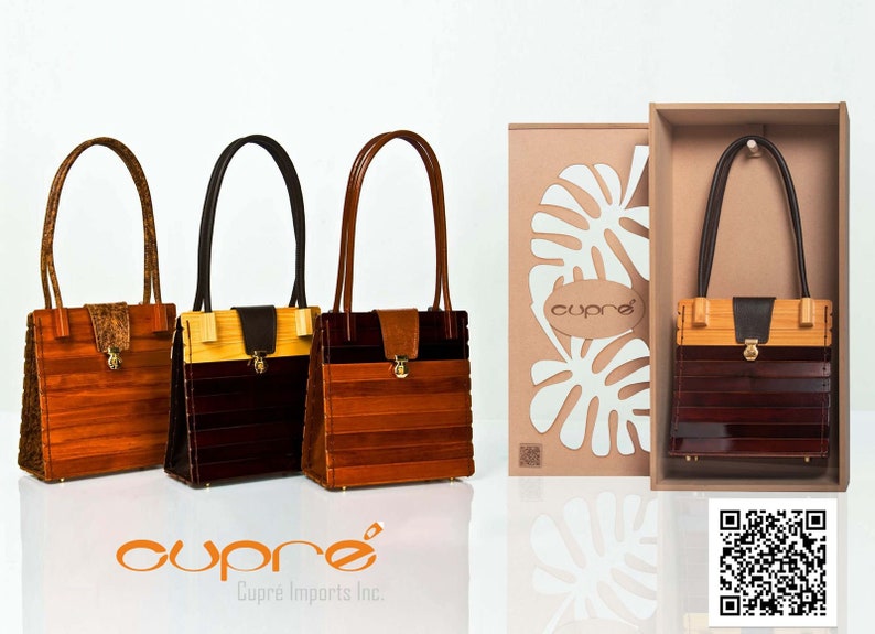 May include: Three wooden handbags with leather handles and accents. The bags feature a rectangular design with horizontal wooden slats in shades of brown and tan. One bag is displayed in a box with a tropical leaf design.