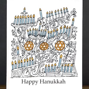 May include: A white greeting card featuring a black ink line drawing of multiple menorahs with light blue candles and yellow flames. Three orange Star of David symbols are centered among the swirling vine patterns. The text Happy Hanukkah is printed in black at the bottom.
