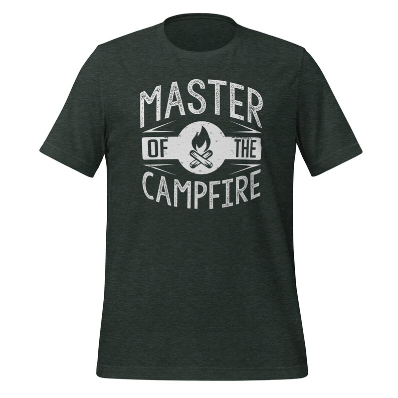 May include: A dark charcoal heather gray short-sleeve t-shirt featuring a white distressed graphic print on the chest. The design includes the text MASTER OF THE CAMPFIRE surrounding a central circular icon of a burning campfire with logs.
