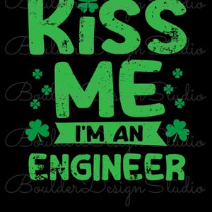 May include: A graphic design on a black background featuring the green text KISS ME I'M AN ENGINEER with a distressed texture. The design includes several four-leaf clover icons and a banner element behind the phrase I'M AN ENGINEER.