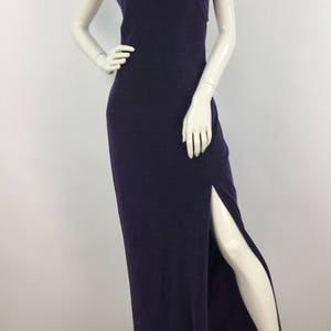 May include: A long, purple, sparkly dress with a high neckline and a slit up the side.