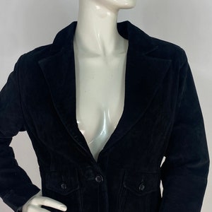 May include: A black velvet blazer with a single button fastening and two flap pockets. The blazer has a classic, tailored fit.