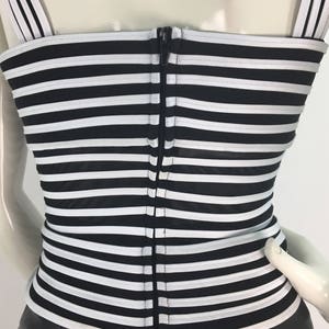 May include: Black and white striped corset top with a zipper down the back.
