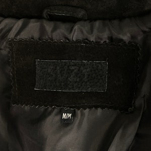 May include: Black suede jacket with a black lining and a label that says "SUZY'S" and "M/M".