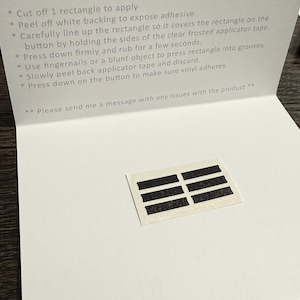 May include: A white card with the words "Thank You" in elegant script. The card includes application tips and a small rectangle with black stripes. The card is open, revealing the contents.