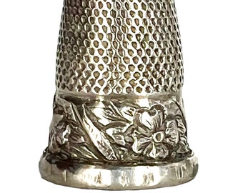 Silver thimble with floral embossed rim