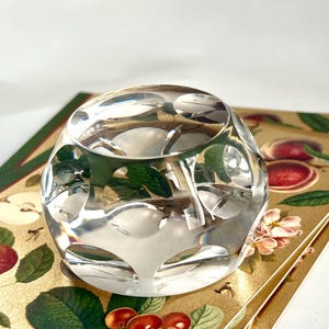 Vintage glass paperweight with flower on its base