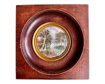 Miniature landscape with a river and trees framed in wood