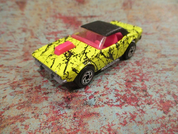 Matchbox 1 64th Scale Diecast Dodge Challenger Yellow With Black Splatter Paint Black Top And Pink Interior 1993