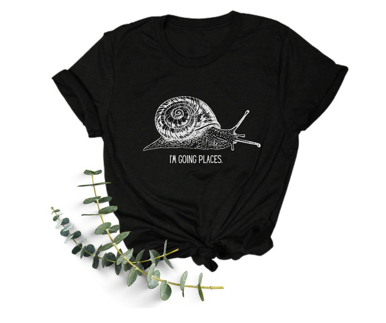 May include: Black t-shirt with a white graphic of a snail and the text "I'm going places."