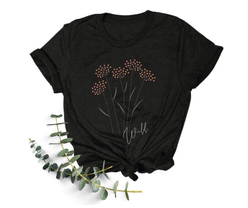 May include: Black t-shirt with a graphic of a cluster of pink flowers and the word "wild" in white script.