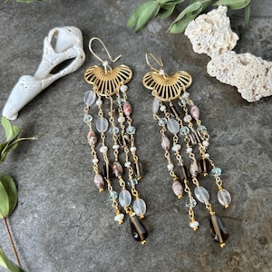 One of a kind gemstone dangle earrings .