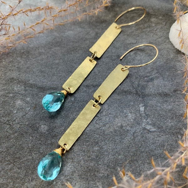 Unique hand forged gemstone earrings .