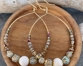 Boho beautiful beaded hoop earrings .