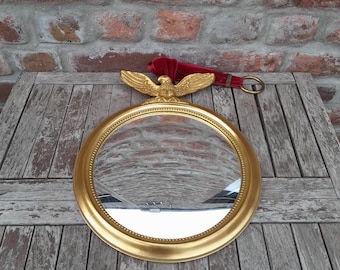 Vintage Midcentury Convex Glass Butler Mirror Witch's Mirror With Gold Colored Frame And Eagle With Burgundy Hanger