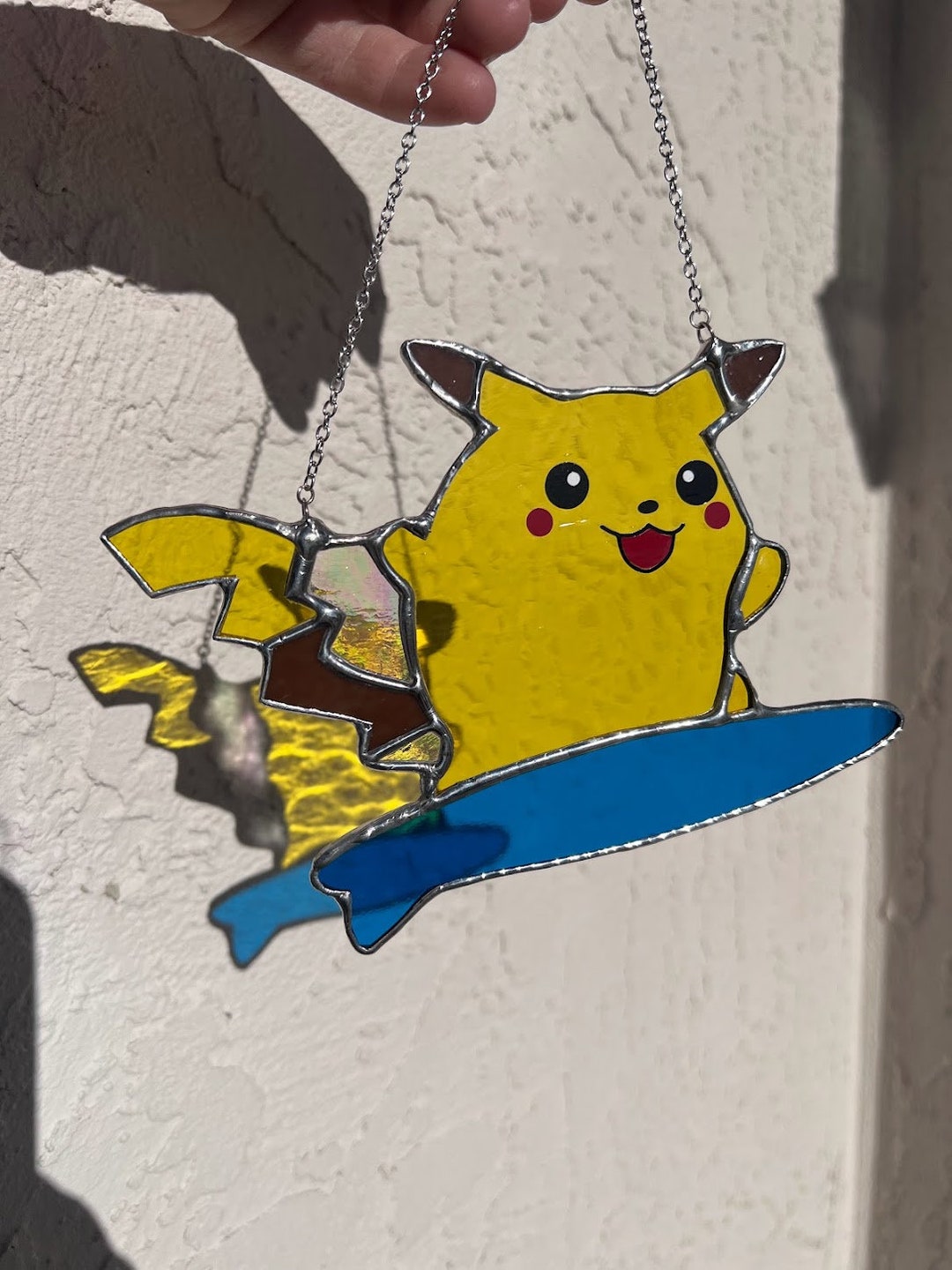 Stained Glass Surfing Pikachu Inspired Hanging Window Suncatcher! So cute! Made with Yellow, Deep Blue, Brown & Iridescent stained glass!