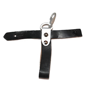 May include: A black leather strap with a silver metal loop and two rivets. The strap has a hook on one end and a loop on the other end.