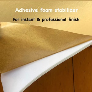 May include: A close-up of a white foam stabilizer with a brown paper backing. The text "Adhesive foam stabilizer" and "For instant & professional finish" is printed on the paper.