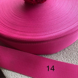 May include: A roll of pink nylon webbing, 1 inch wide. The webbing is rolled up and the end of the roll is labeled with the number "14".