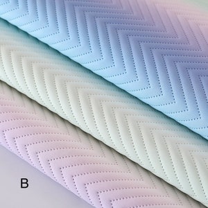 May include: Three pieces of fabric with a chevron pattern in shades of blue, green, and purple. The fabric has a textured surface and is quilted.
