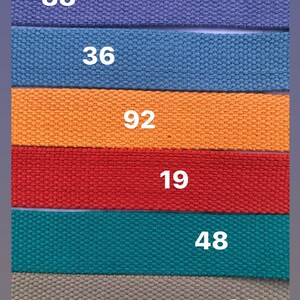 May include: Six different colored fabric straps with numbers printed on them. The numbers are 88, 36, 92, 19, 48, and 39.